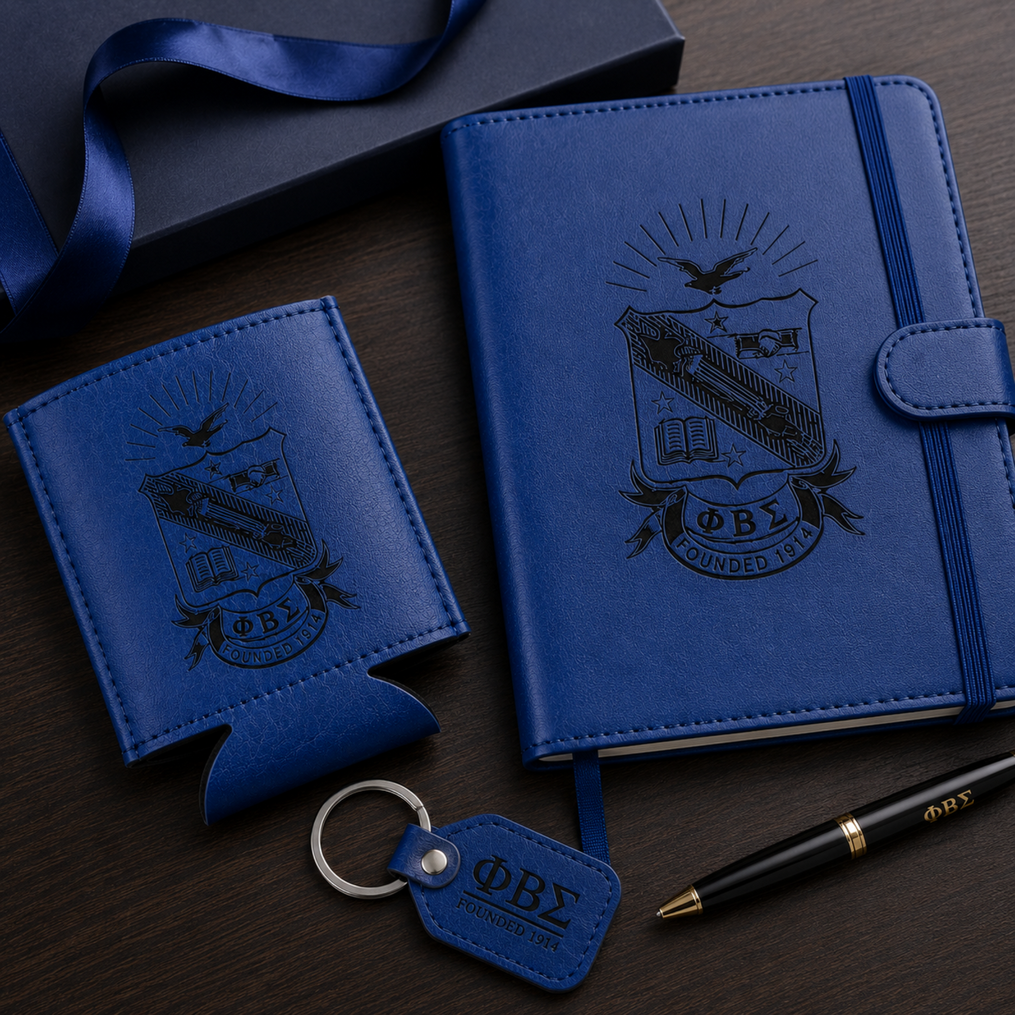 Blue leather notebook with embossed design, keychain, and pen on a dark surface