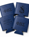 Four blue can coolers with engraved text and symbols on a white background