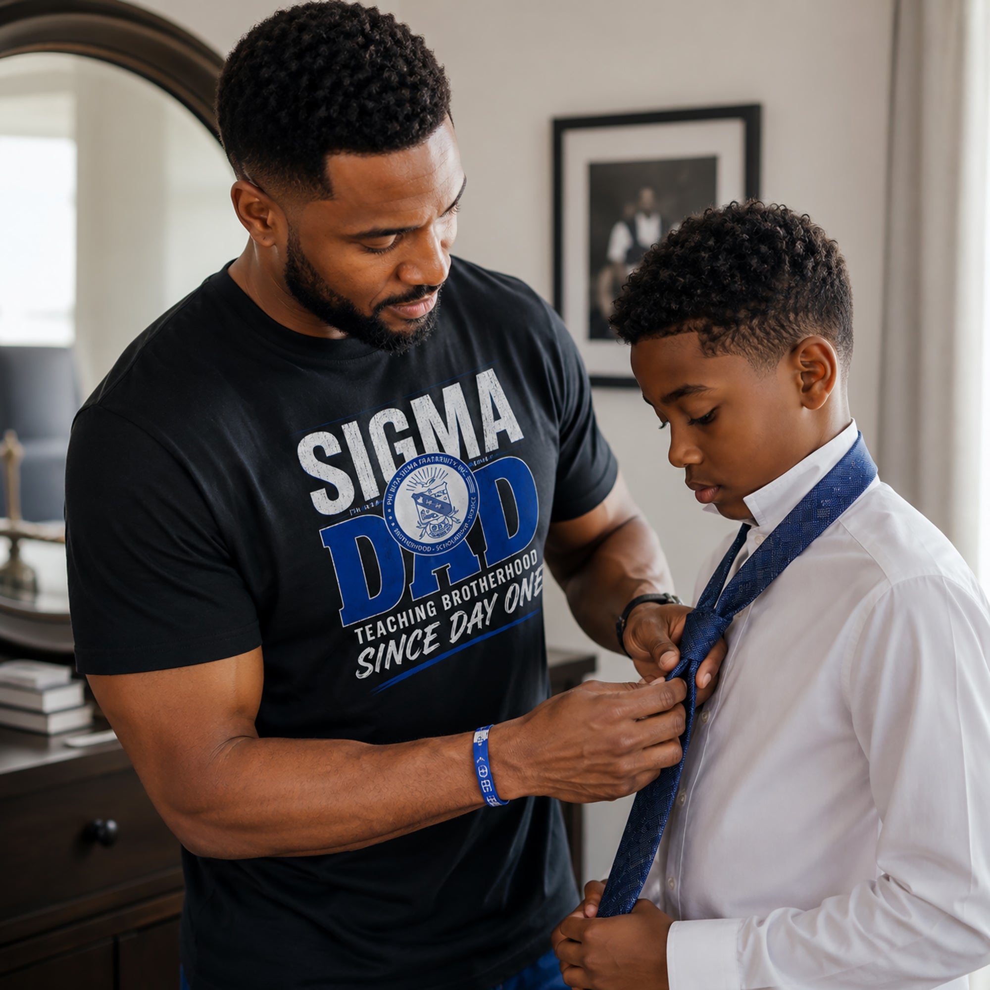 Phi Beta Sigma father teaching his son while wearing Sigma Dad shirt