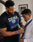 Phi Beta Sigma father teaching his son while wearing Sigma Dad shirt