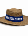 A natural woven straw boater hat with a wide blue band featuring the white text 'PHI BETA SIGMA'.