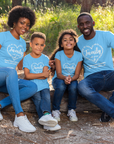 Matching Carolina blue family reunion T-shirts worn by a family outdoors