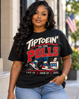 Black woman wearing the black Tiptoein’ to the Polls T-shirt