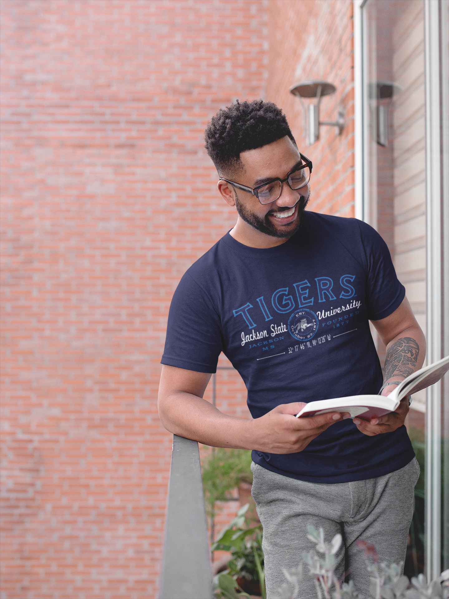 Navy crew-neck short-sleeve T-shirt with blue Tigers university graphic, worn by model