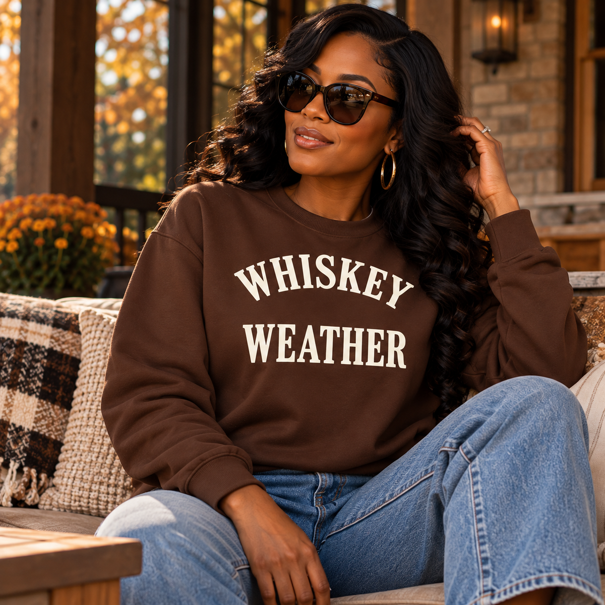 Black woman wearing Chocolate Brown Whiskey Weather crewneck sweatshirt in an autumn lifestyle setting