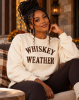 Black woman wearing Natural Whiskey Weather crewneck sweatshirt with dark chocolate brown print