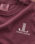 Close-up of the front chest JL logo on the Women Who Build Beach Wash Tee