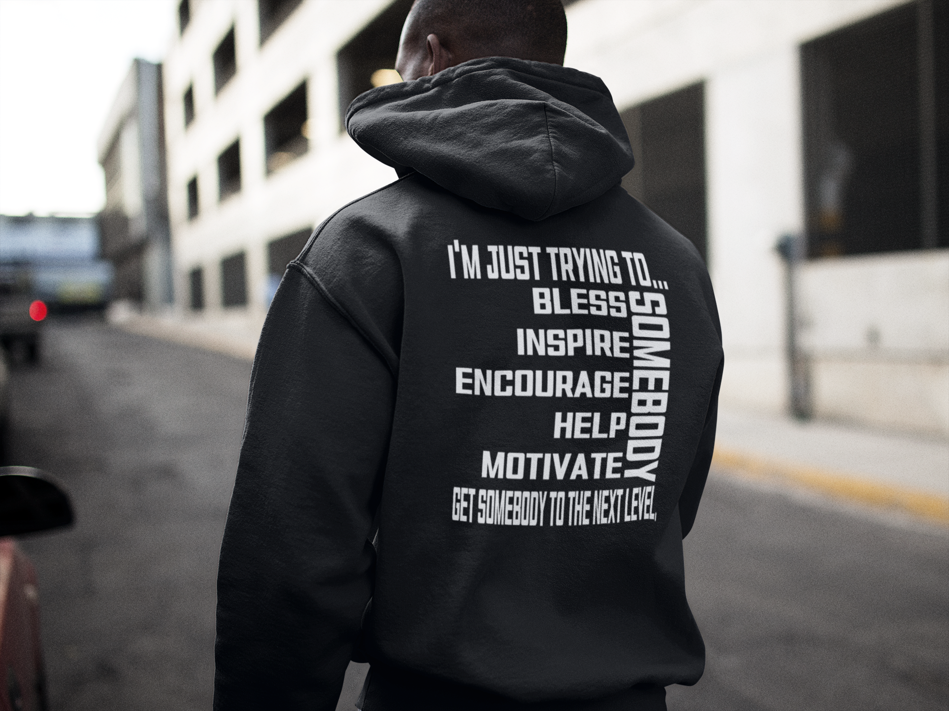 Black pullover hoodie with hood and large back motivational quote text graphic