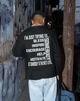 Black unisex crew neck long sleeve T-shirt with bold white back slogan text