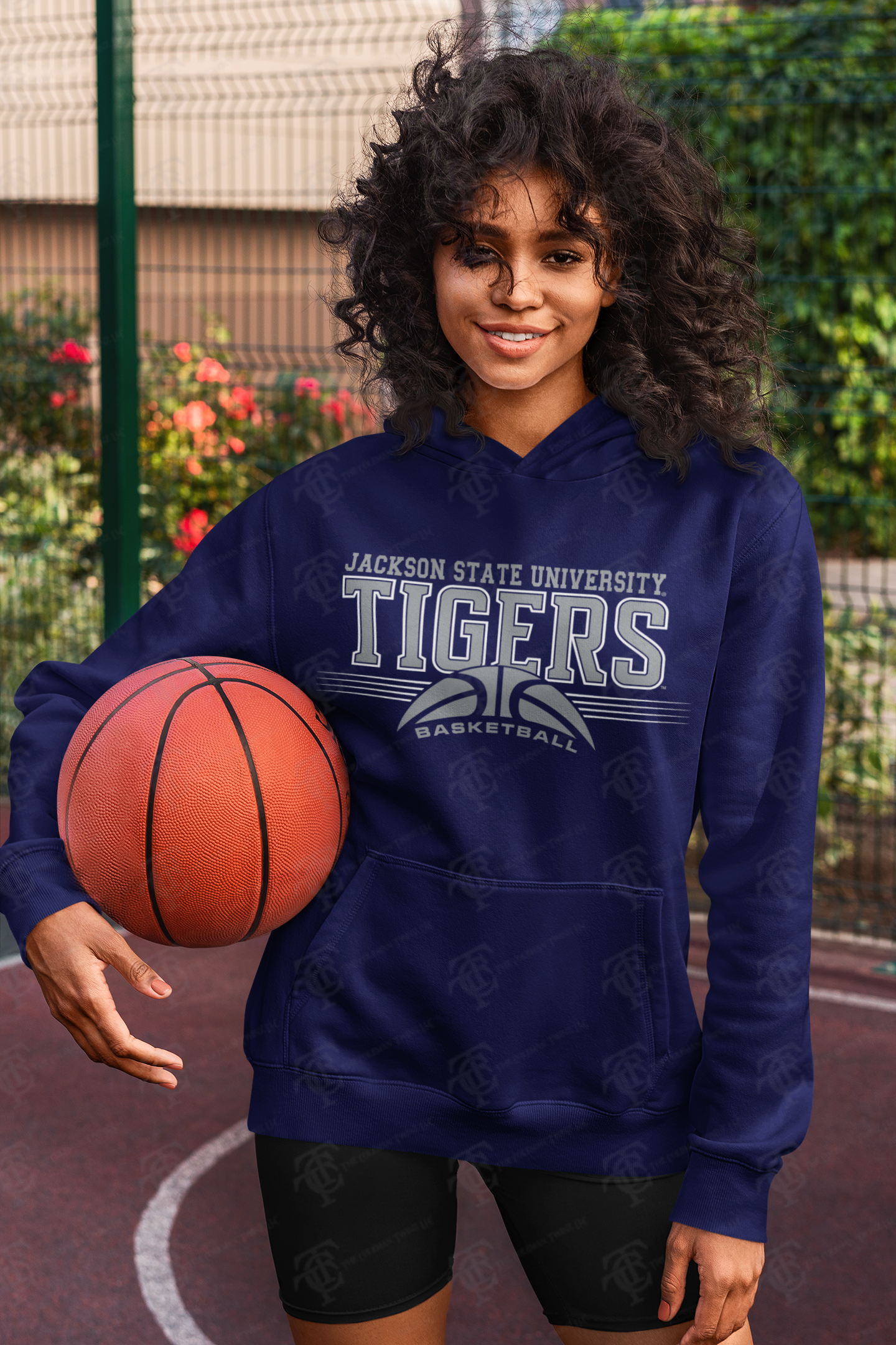 Navy unisex pullover hoodie with Tigers basketball logo and kangaroo pocket on model