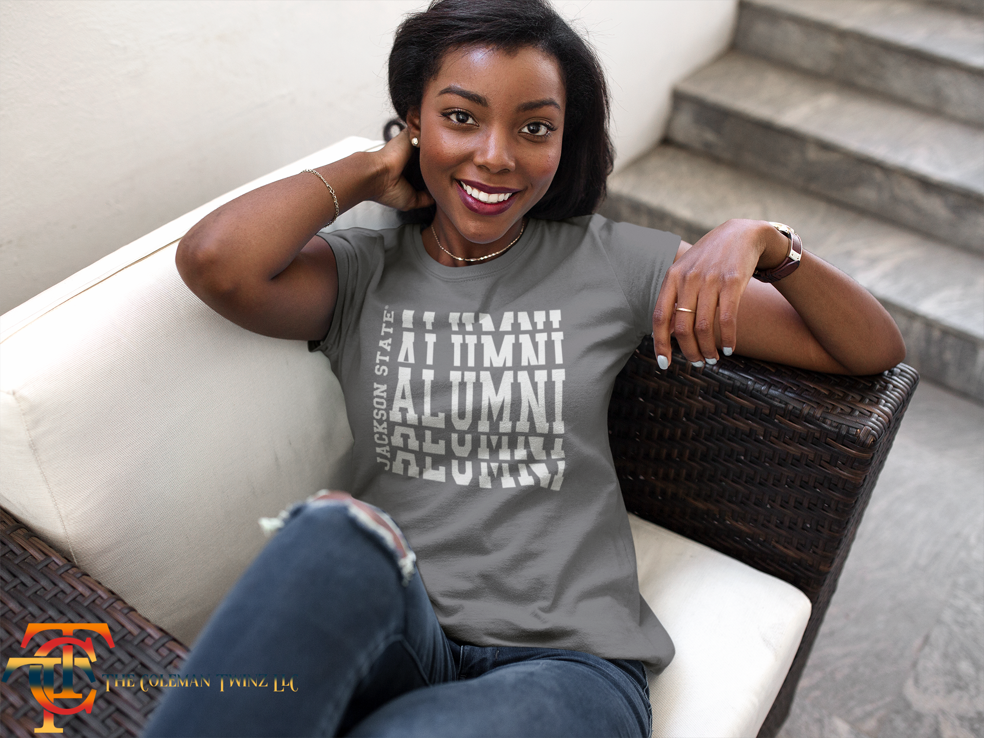 Gray crew-neck short sleeve T-shirt with white stacked “Alumni” graphic on model