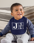 Infant bib on baby in navy blue with white JSU block letter logo