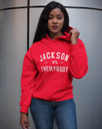 Red pullover hoodie with front pocket and white slogan text