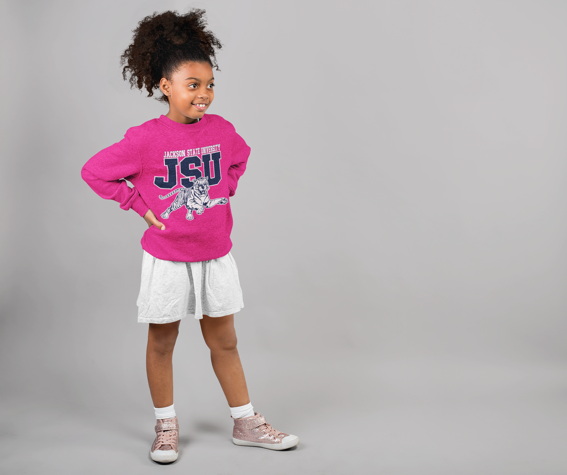 Youth crewneck sweatshirt in fuchsia pink with leaping tiger logo, worn by child