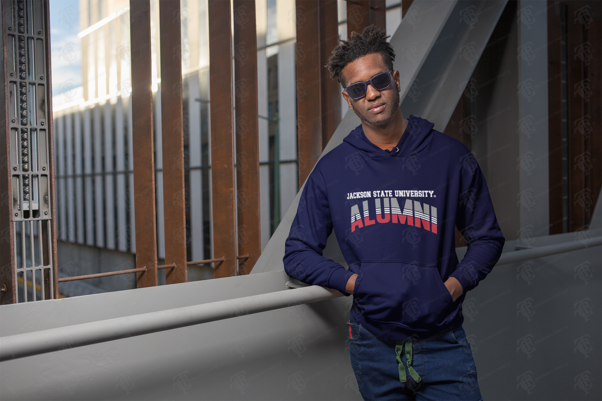Navy unisex pullover hoodie with “Alumni” graphic, front view on model