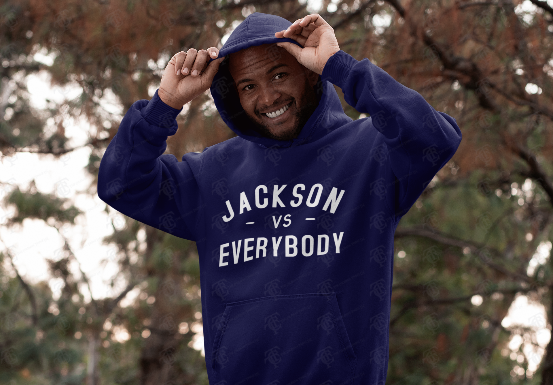 Navy pullover hoodie worn, with white 'JACKSON VS EVERYBODY' front print and drawstring hood