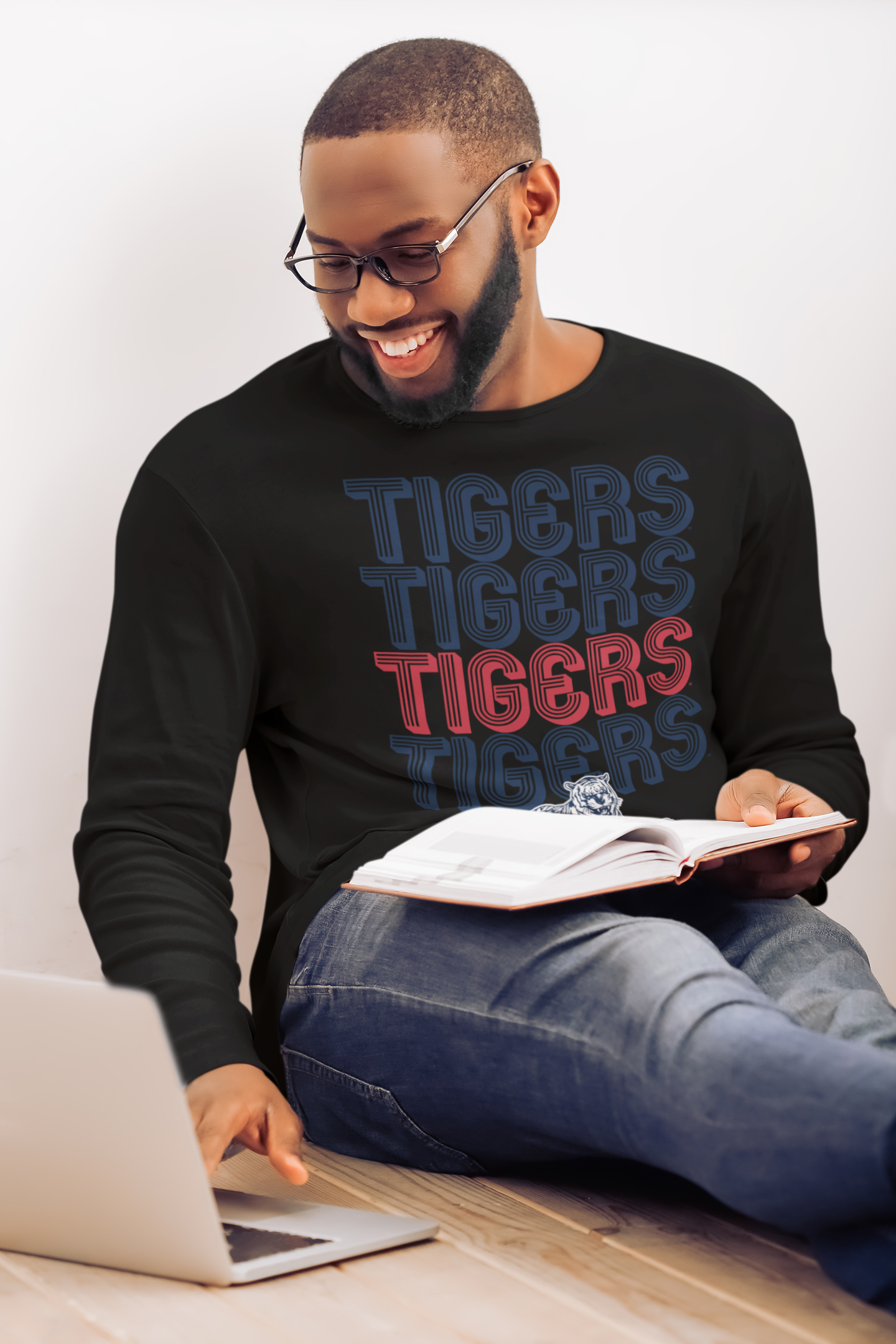 Black long-sleeve crewneck T-shirt with stacked Tigers text and tiger mascot graphic