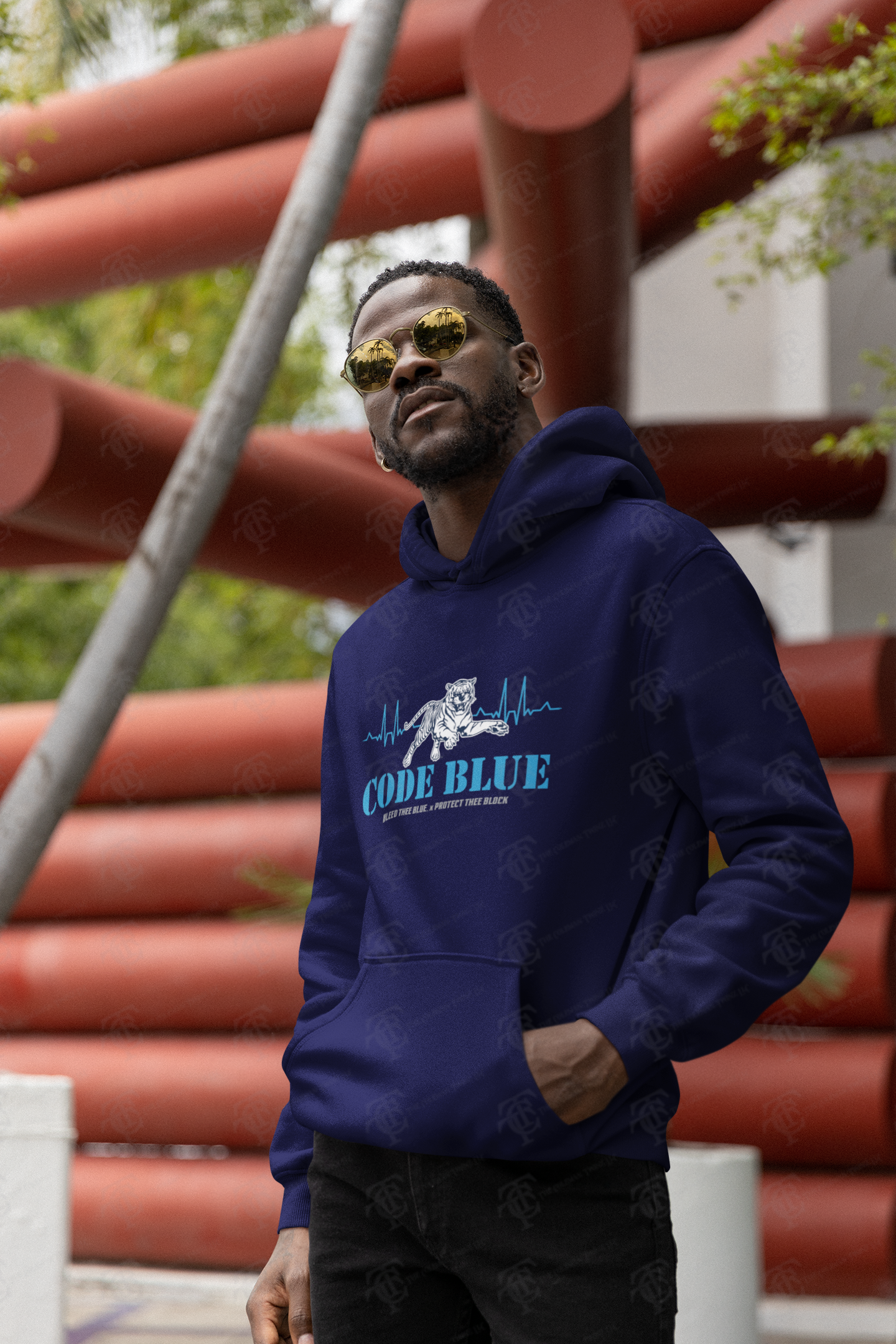 Navy pullover hoodie with 'Code Blue' illustrated chest graphic, worn by model.