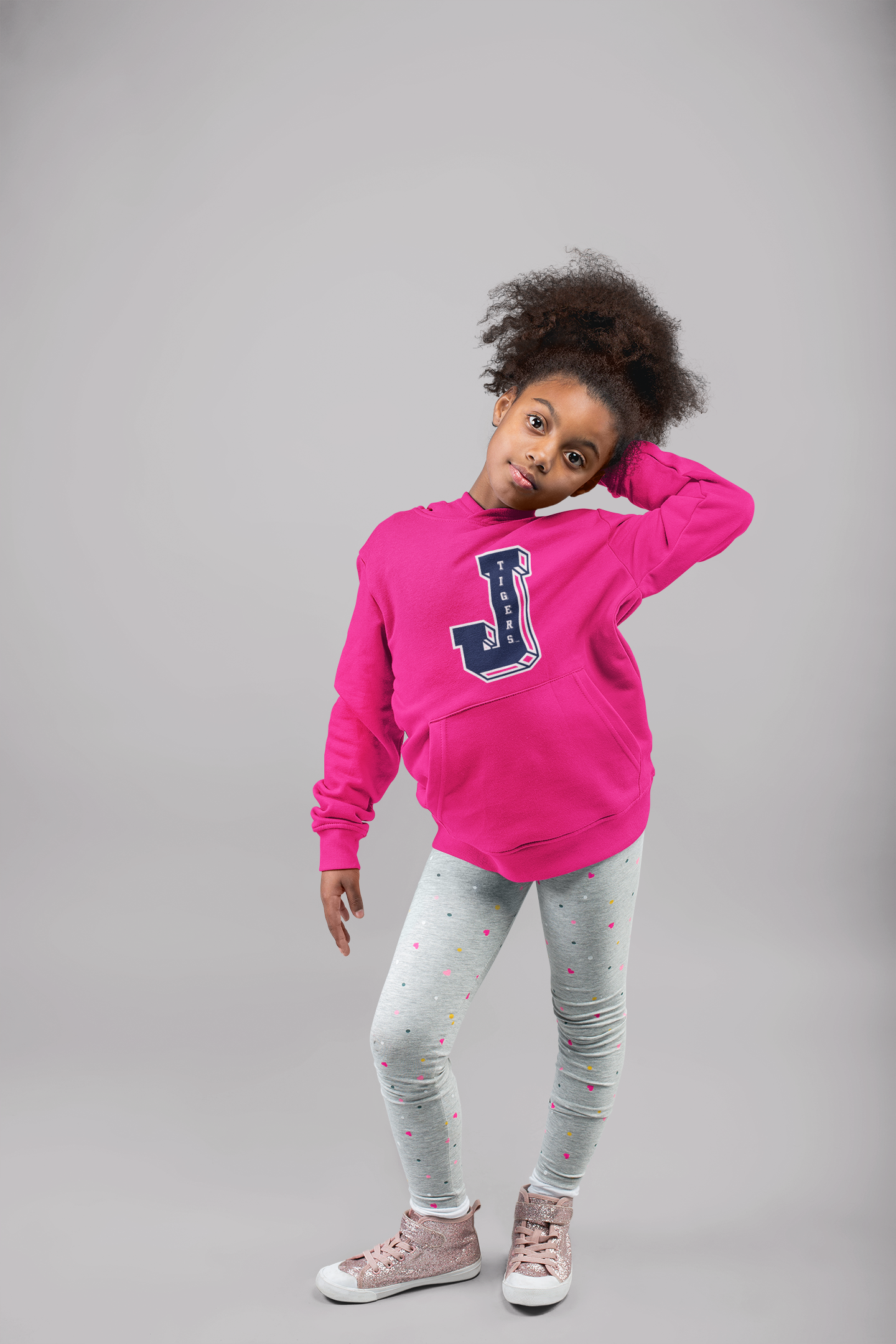 Pink youth pullover hoodie with J Tigers logo on chest, worn by a child
