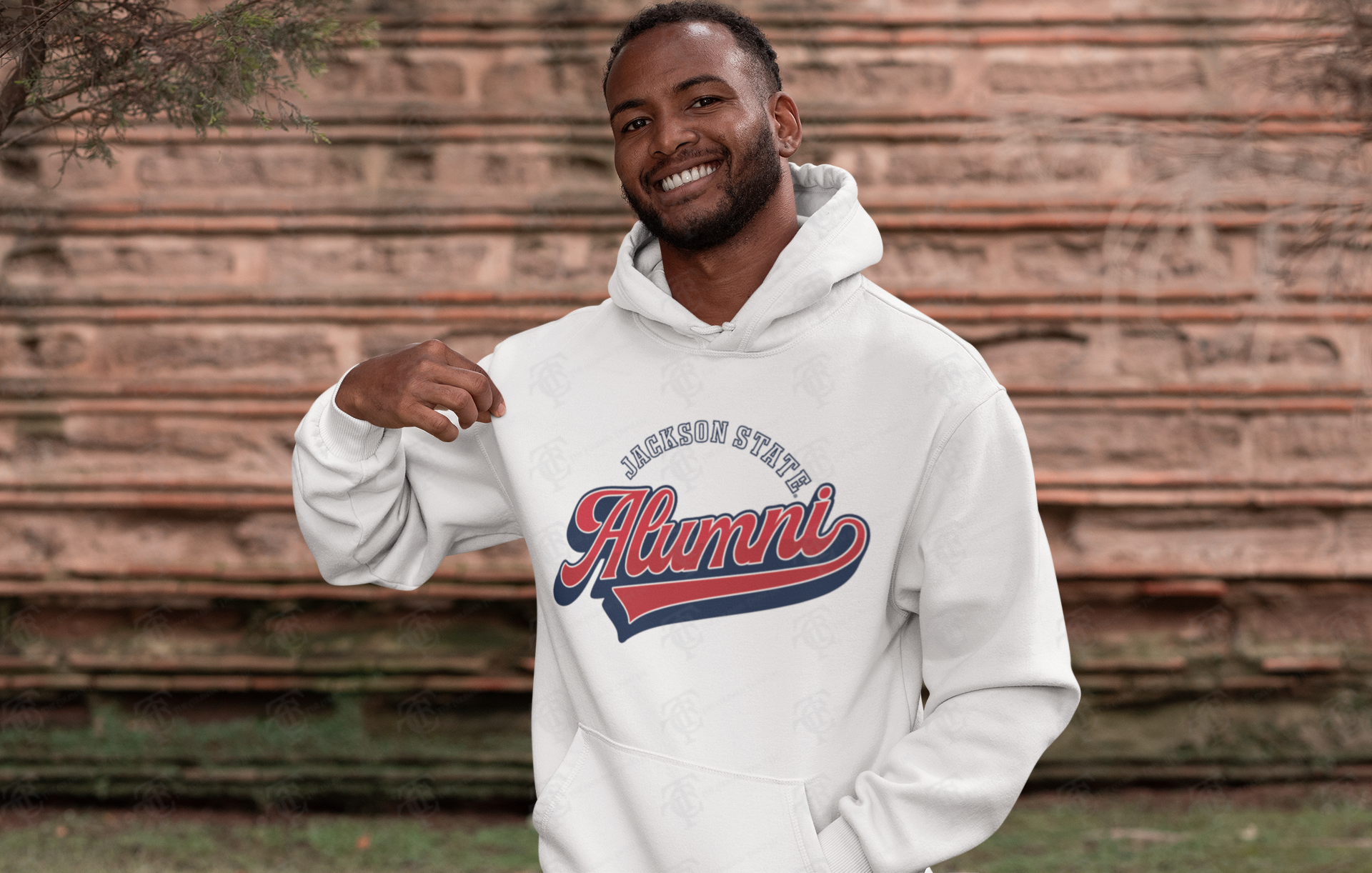 White pullover hoodie with Alumni logo on chest, worn by a smiling man