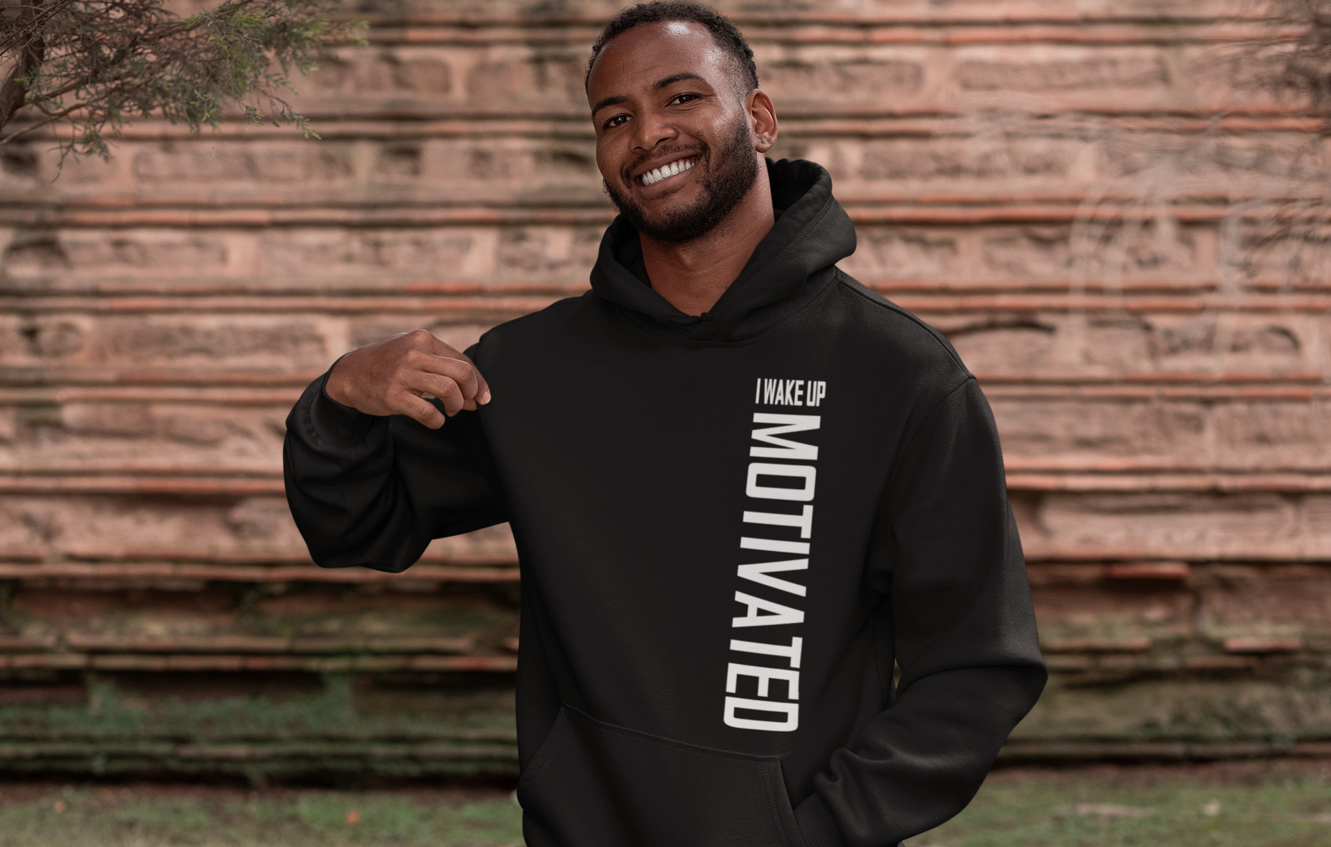 Black pullover hoodie with hood and front 'I WAKE UP MOTIVATED' lettering graphic
