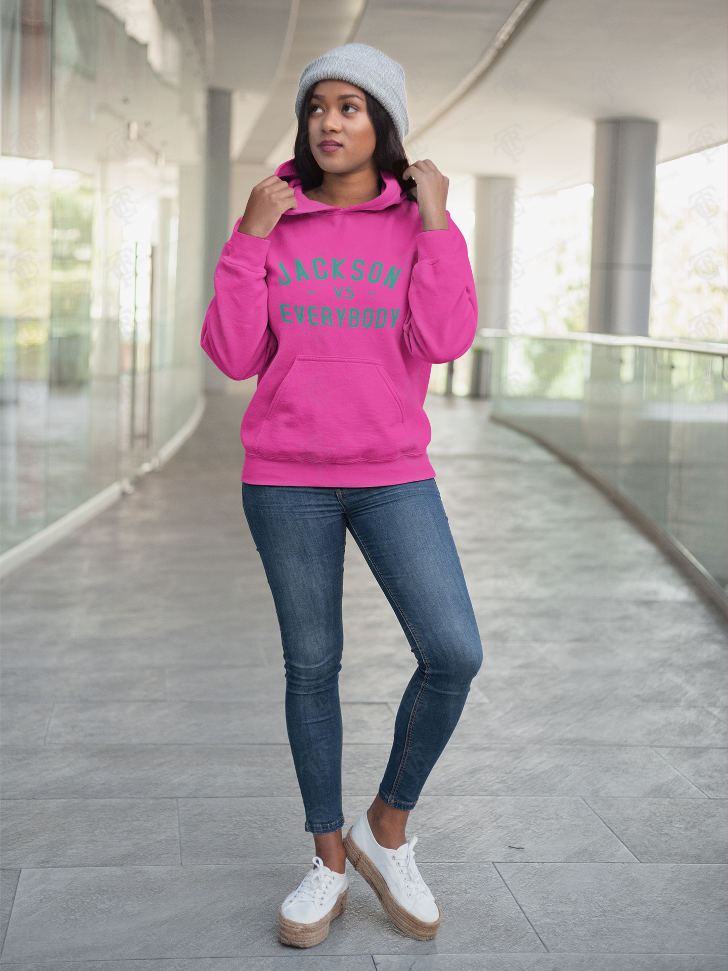 Pink pullover hoodie with front pocket and green slogan lettering