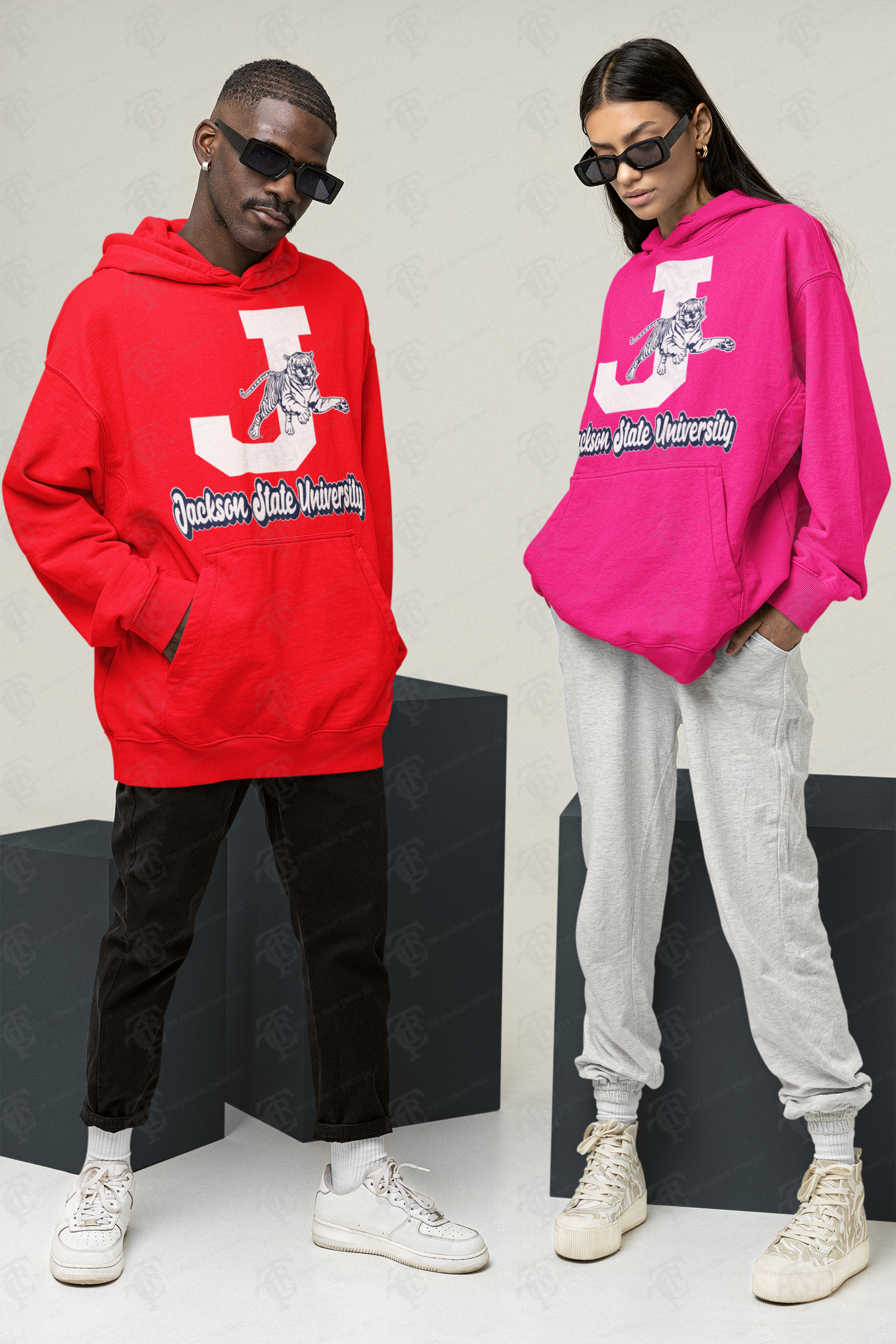 Two pull-over hoodies: red and pink, each with white J and leaping tiger graphic