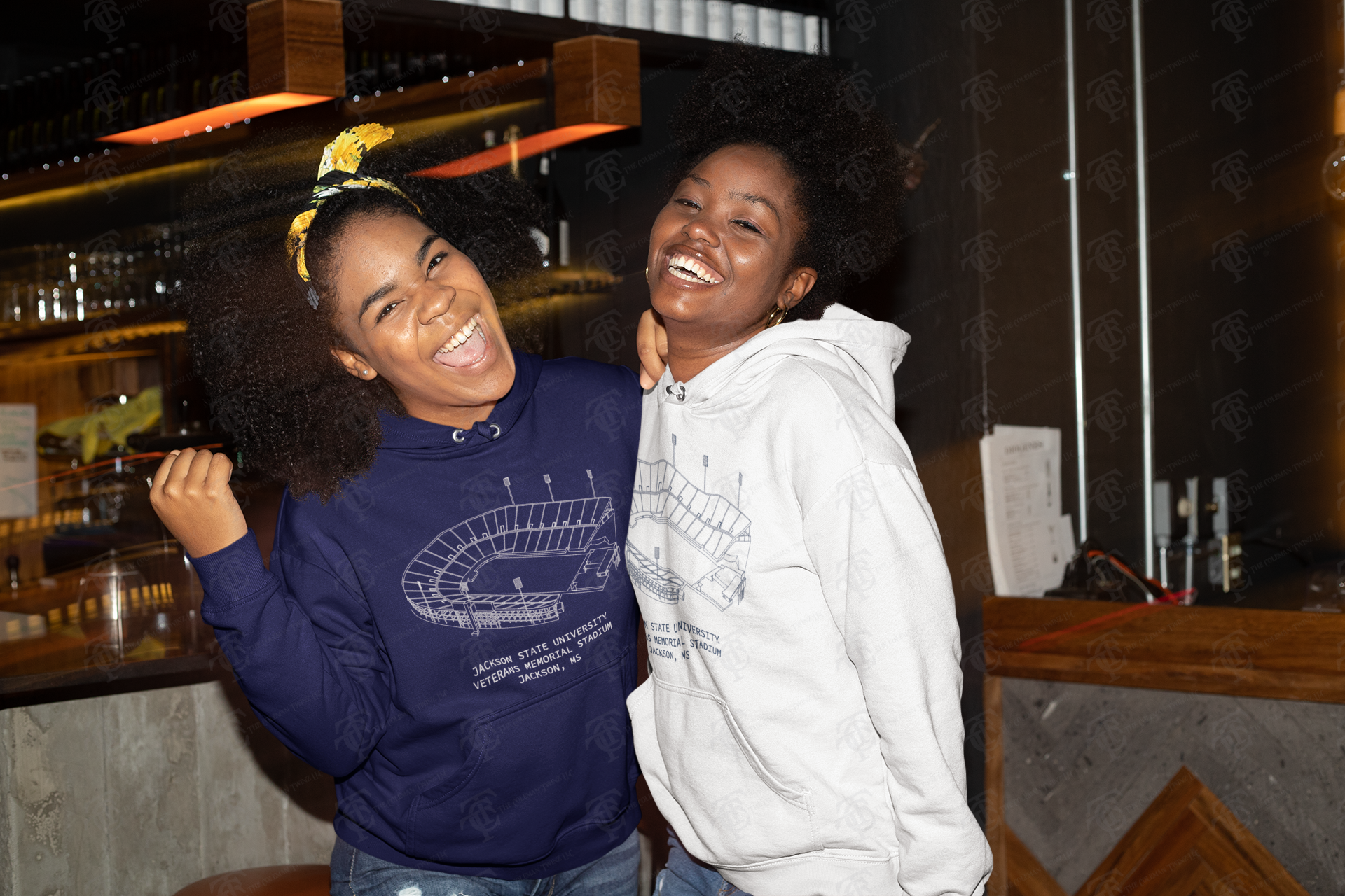 Pair of unisex pullover hoodies: navy and white with stadium graphics