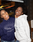 Pair of unisex pullover hoodies: navy and white with stadium graphics