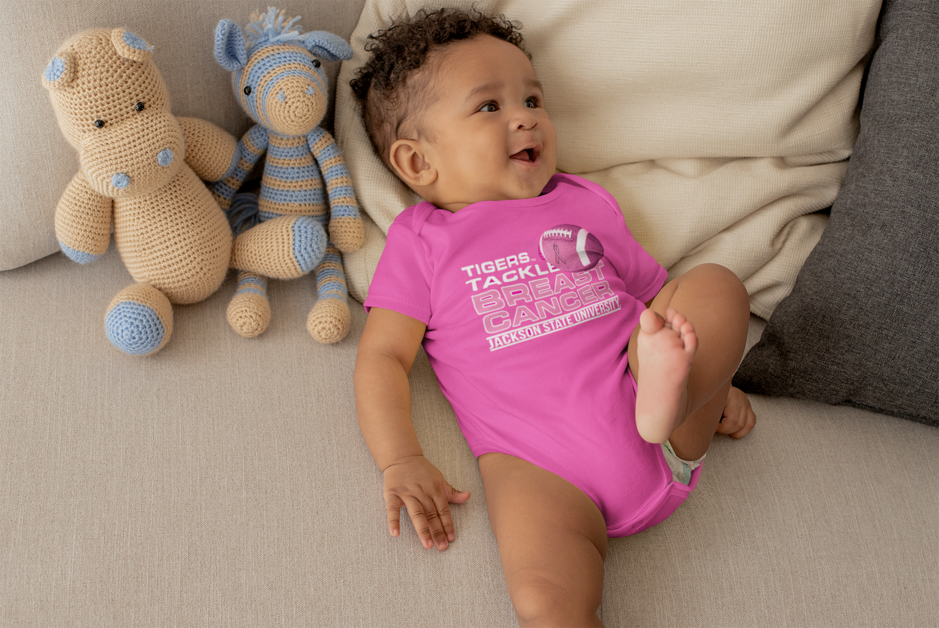Pink infant bodysuit with round neck and front breast cancer graphic