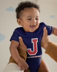 Infant wearing navy short sleeve bodysuit with J logo and Jackson State University print