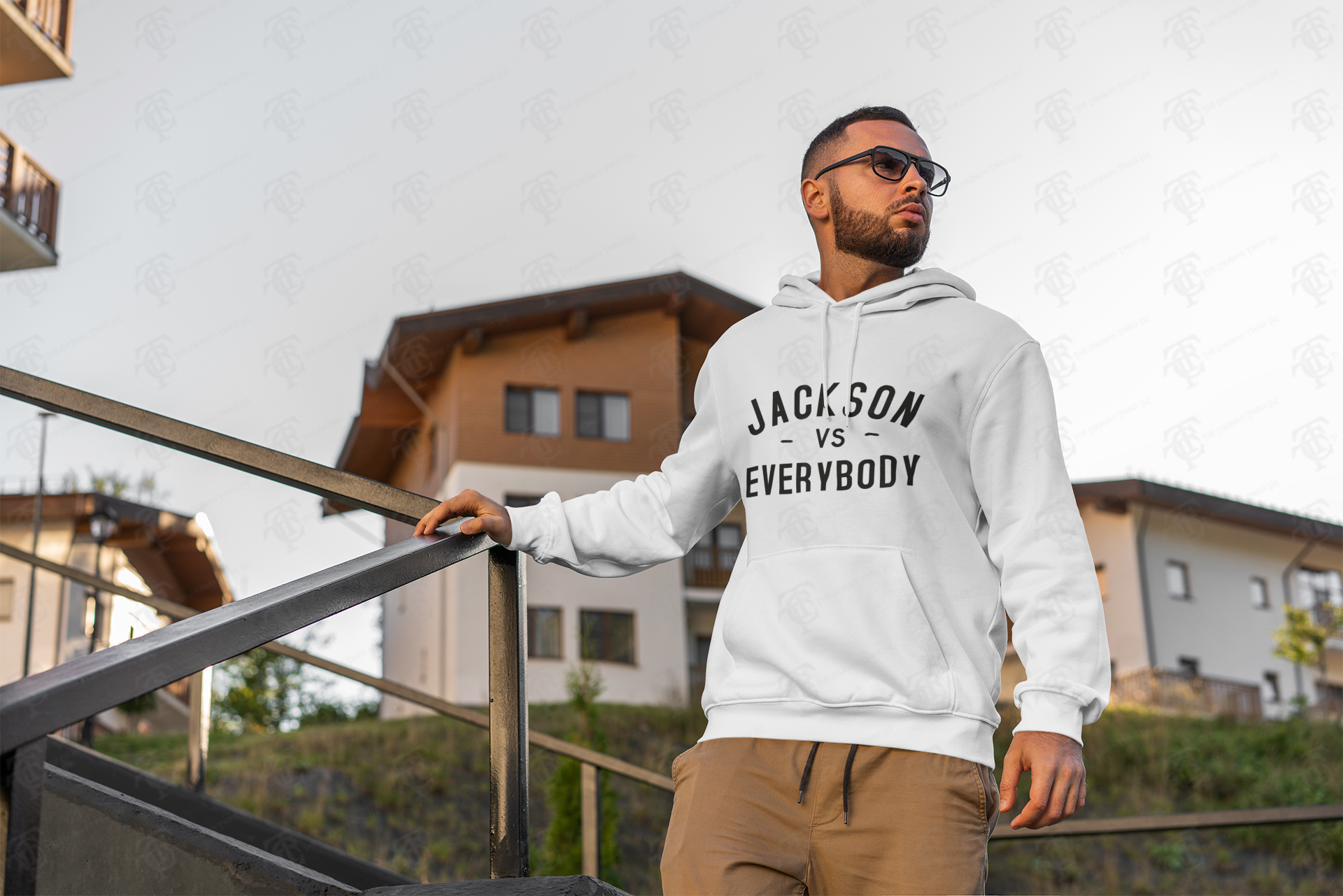 White pullover hoodie worn, with 'JACKSON VS EVERYBODY' front print and drawstring hood