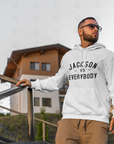 White pullover hoodie worn, with 'JACKSON VS EVERYBODY' front print and drawstring hood