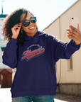 Navy pullover hoodie with Alumni logo on chest, worn by a smiling woman outdoors