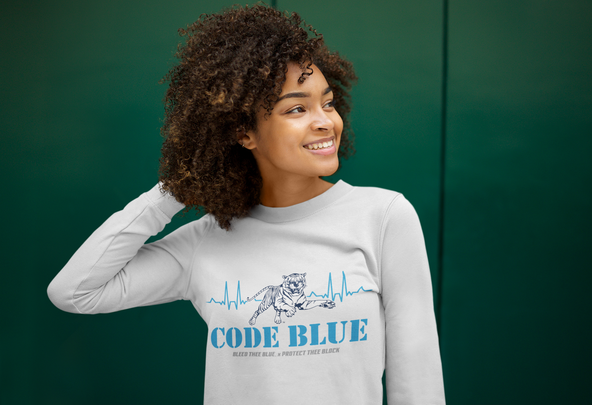 White long sleeve crewneck T-shirt with “CODE BLUE” wolf heart-rate graphic, on model