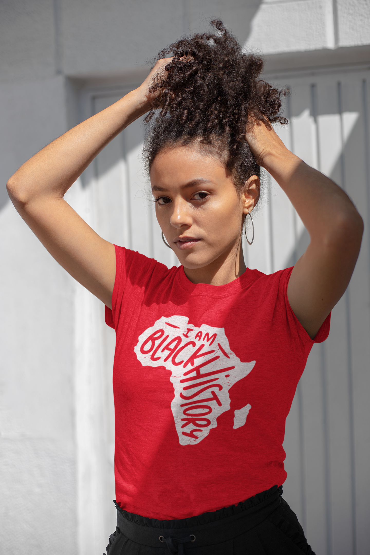 Red short-sleeve T-shirt with white 'I Am Black History' map graphic, model wearing