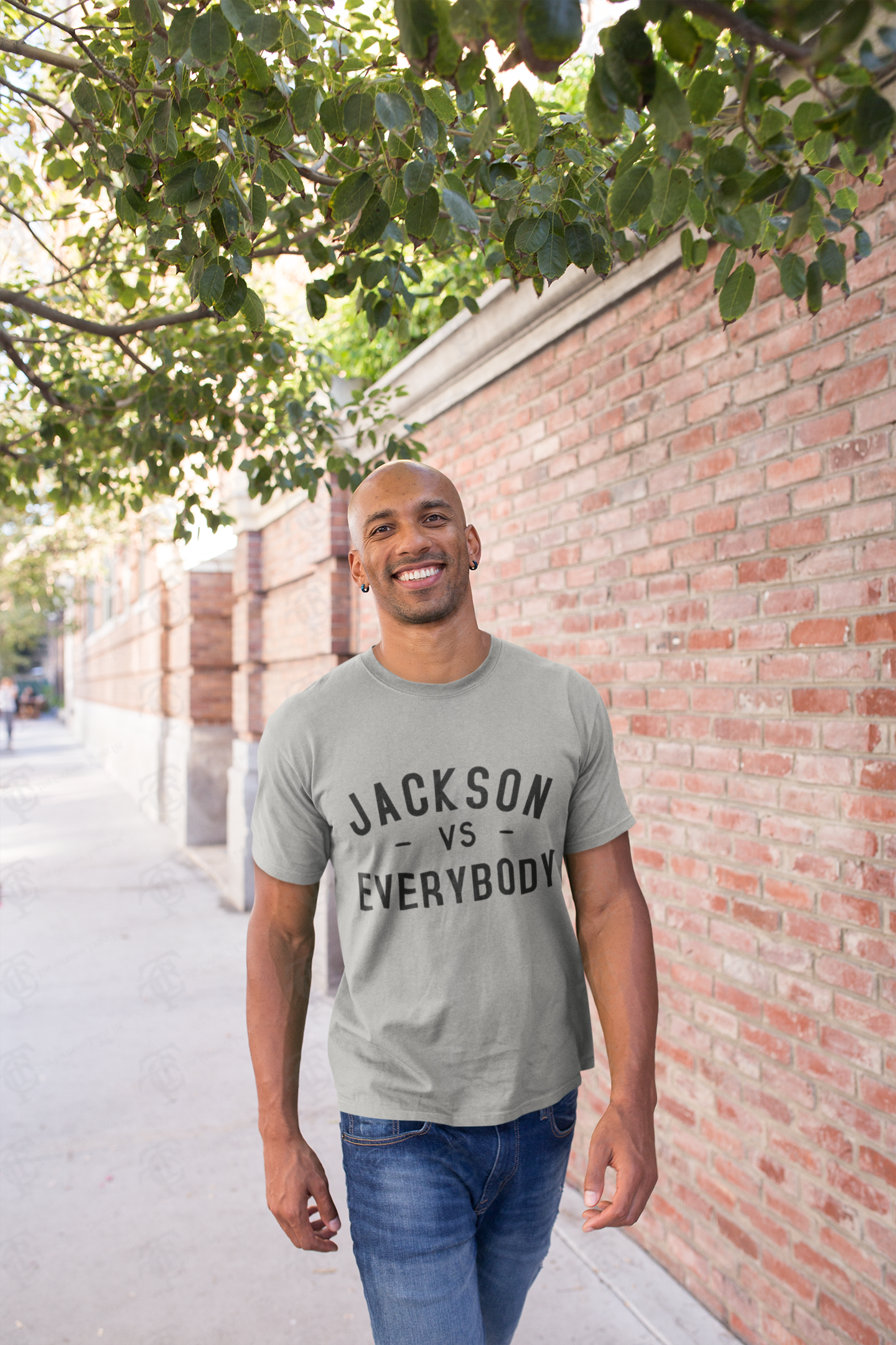 Light gray short sleeve crewneck T-shirt with black “JACKSON vs EVERYBODY” text.