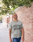 Light gray short sleeve crewneck T-shirt with black “JACKSON vs EVERYBODY” text.