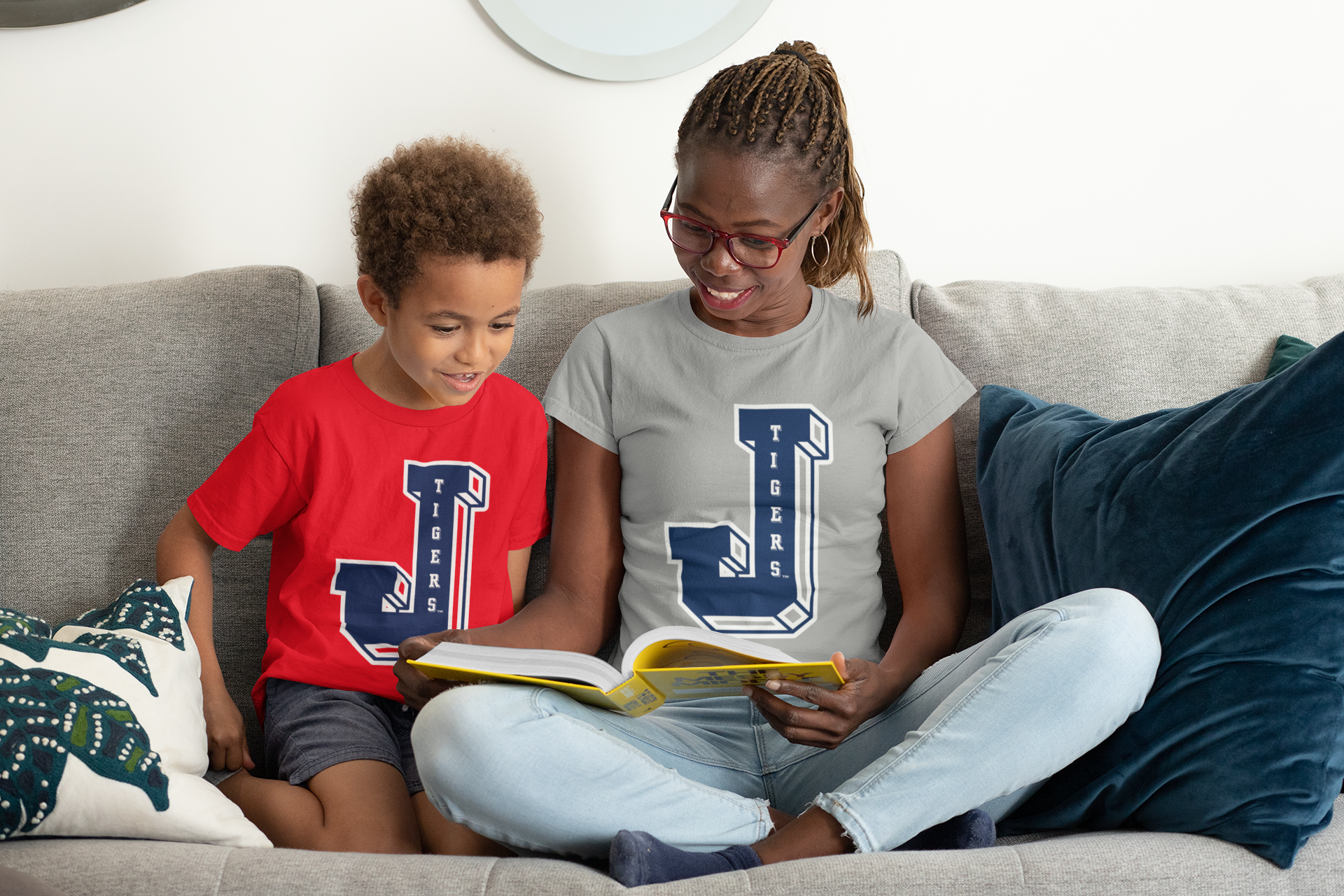 Two toddlers wearing red and light gray crewneck T-shirts with Tigers J logos