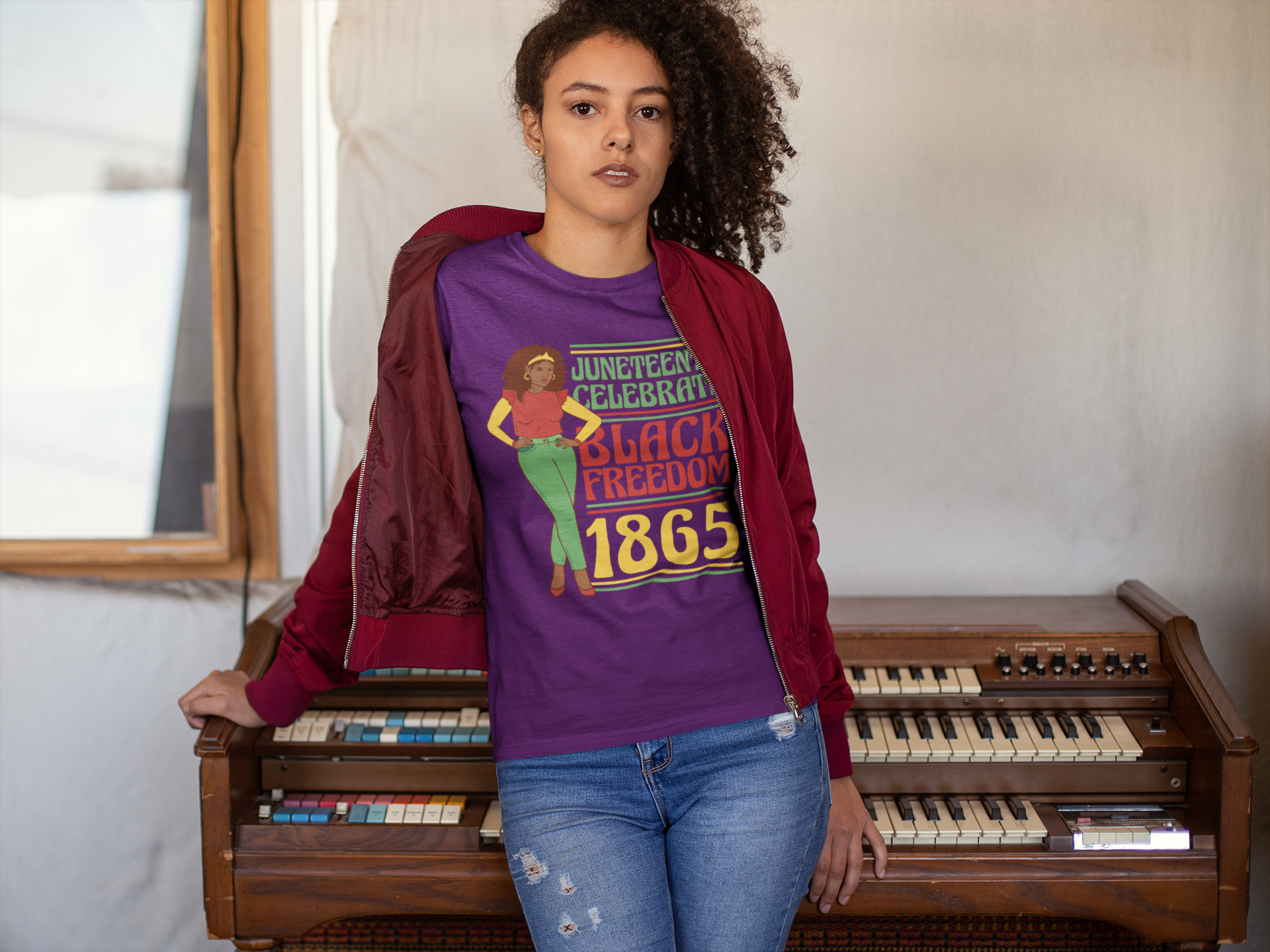 Purple Juneteenth T-shirt worn by woman; 'Black Freedom 1865' front graphic