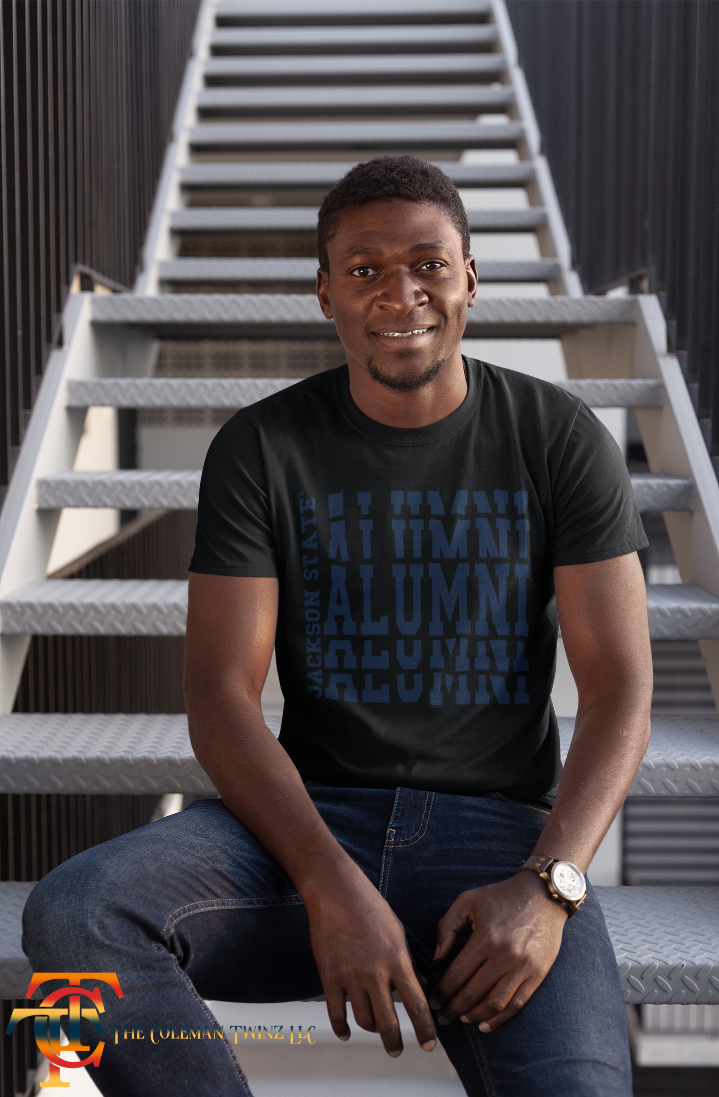 Black crew neck t-shirt with stacked alumni logo print on front, worn by model