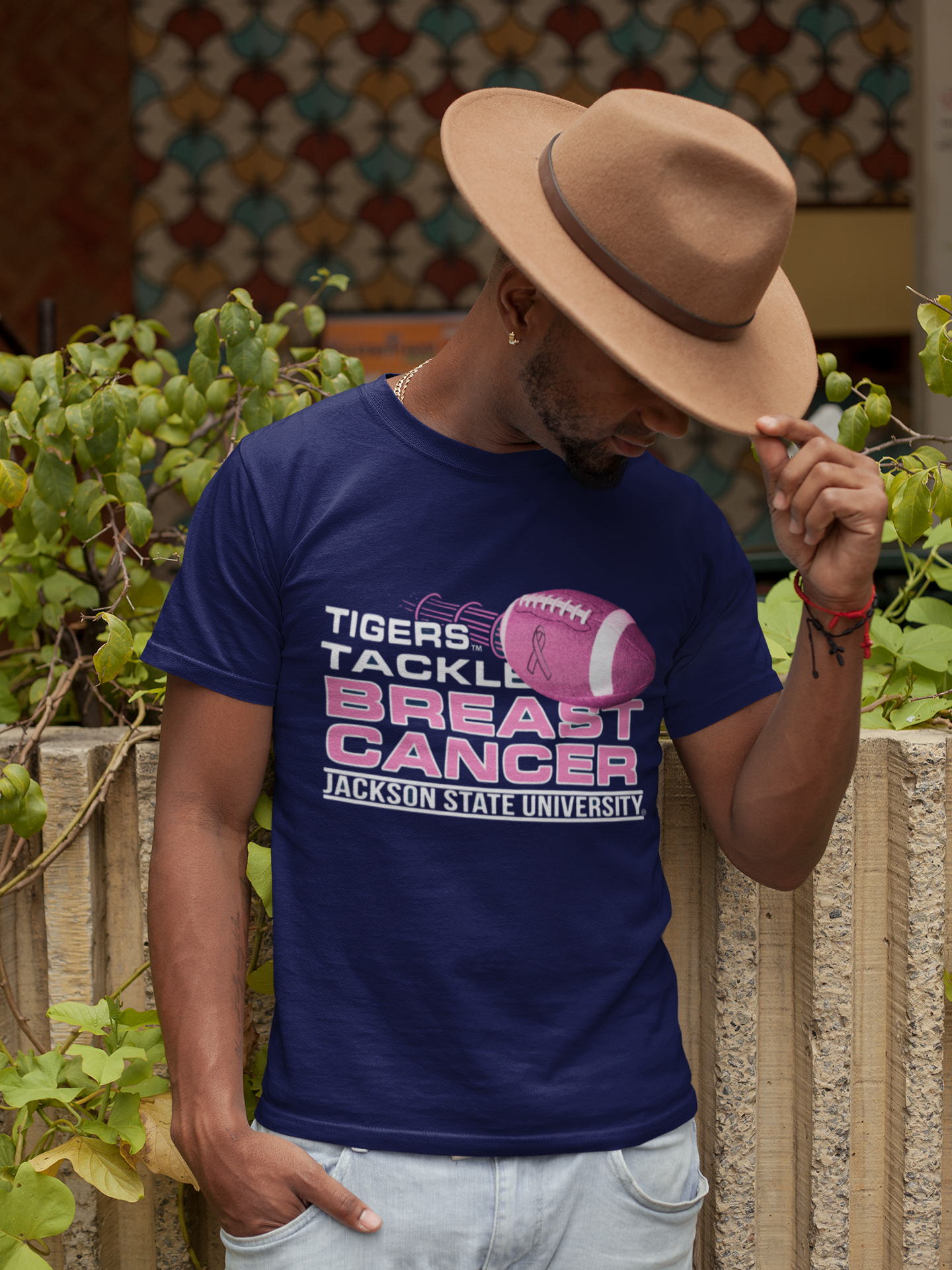 Navy crew-neck T-shirt with “Tigers Tackle Breast Cancer” football graphic on wearer