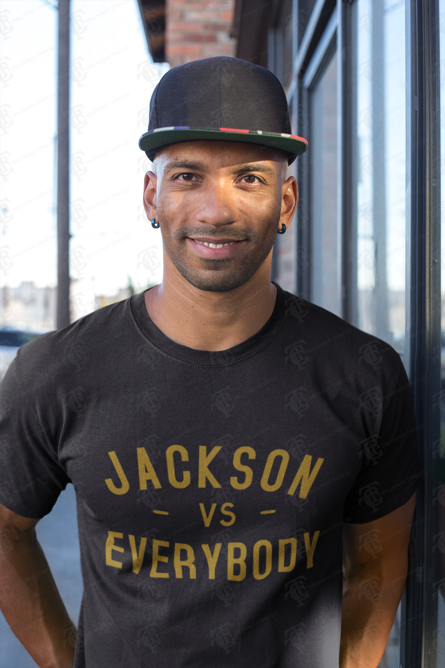 Black short sleeve crewneck T-shirt with gold “JACKSON vs EVERYBODY” lettering.