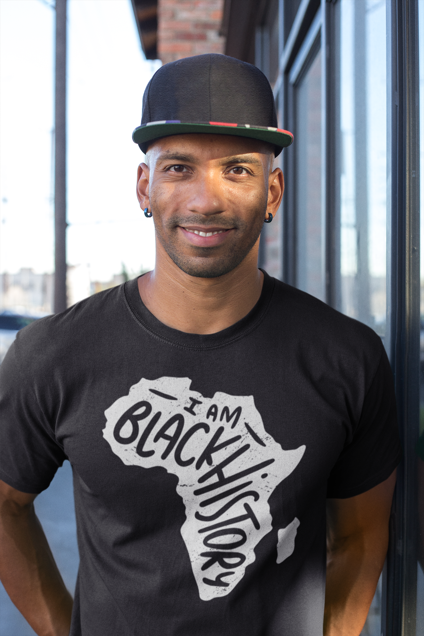 Black short-sleeve T-shirt with white 'I Am Black History' map graphic, model wearing