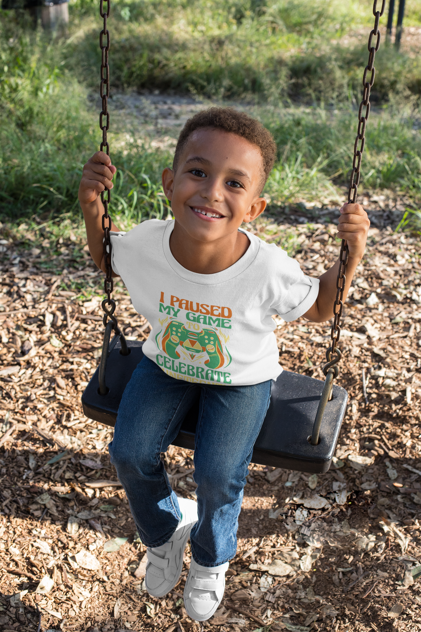 White kids T-shirt with “I Paused My Game To Celebrate Juneteenth” front graphic