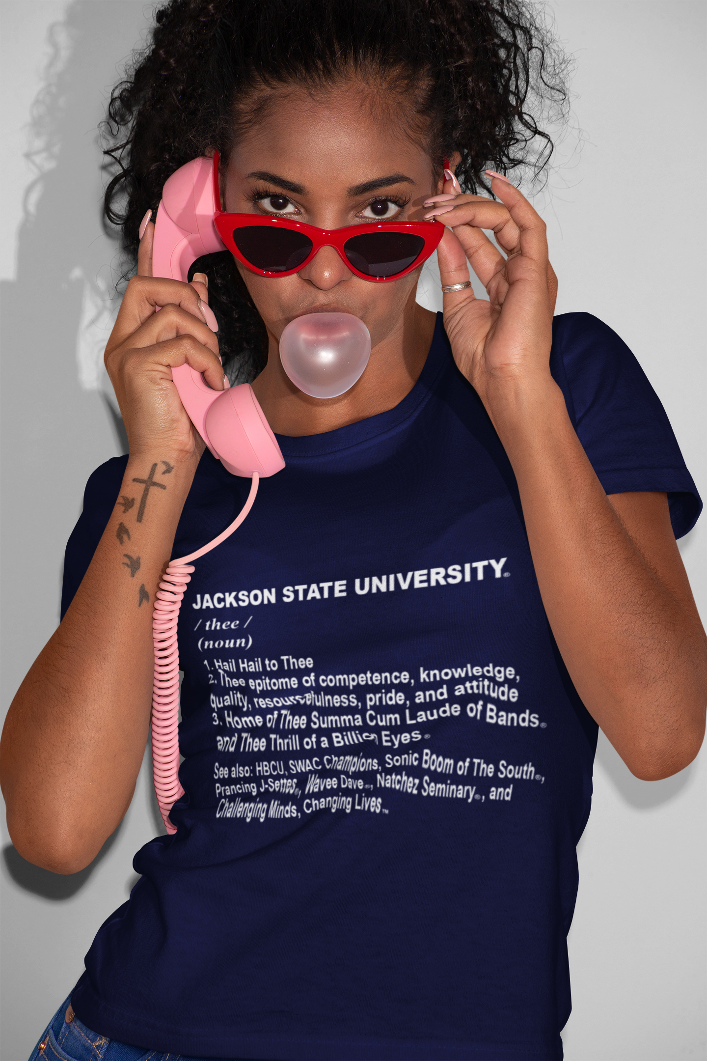 Person wearing navy short-sleeve crewneck T-shirt with Jackson State University 'thee' text.