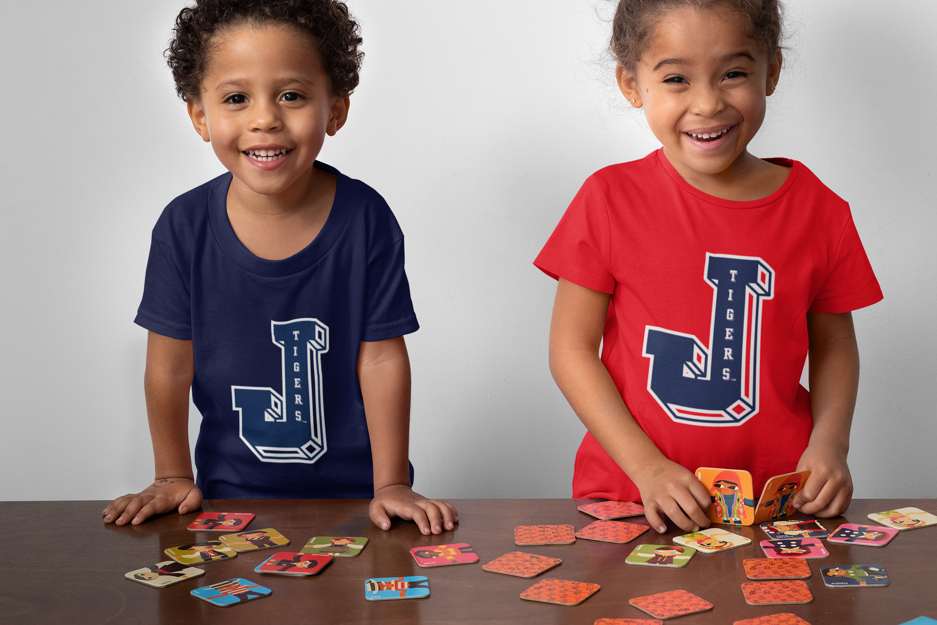 Two toddlers in navy and red crewneck T-shirts with Tigers J logo graphics